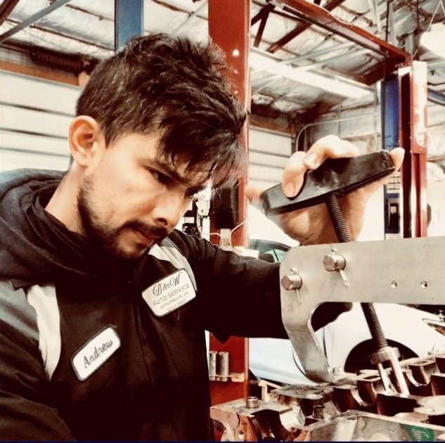 B & W Auto Service technician Andrew working under a lifted vehicle